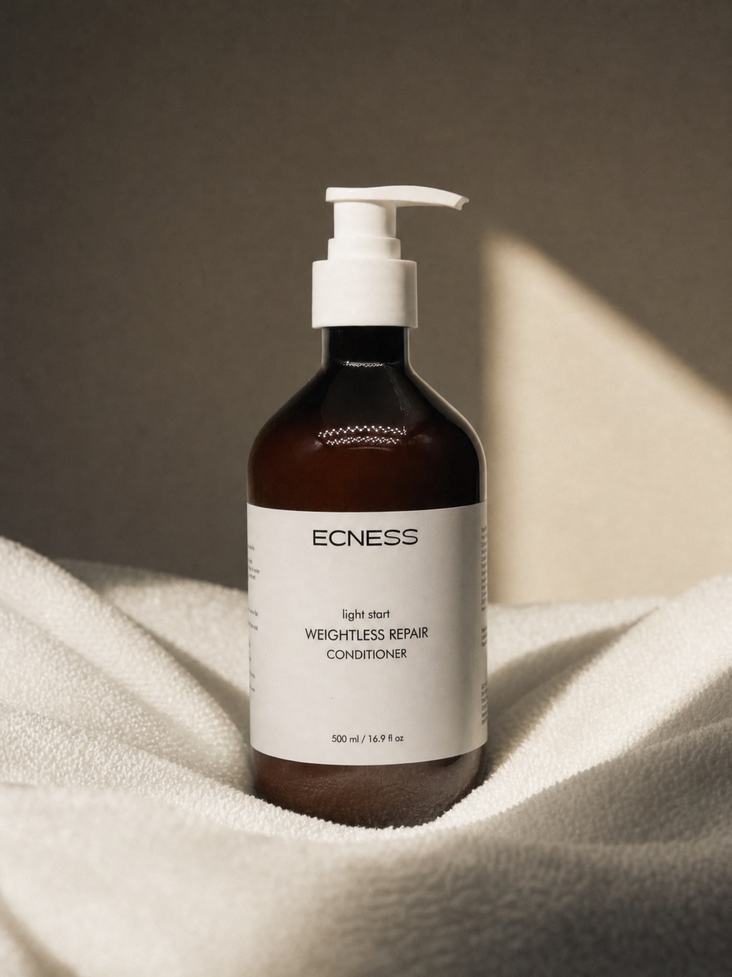 ECNESS Weightless Repair Conditioner in a soft towel setting