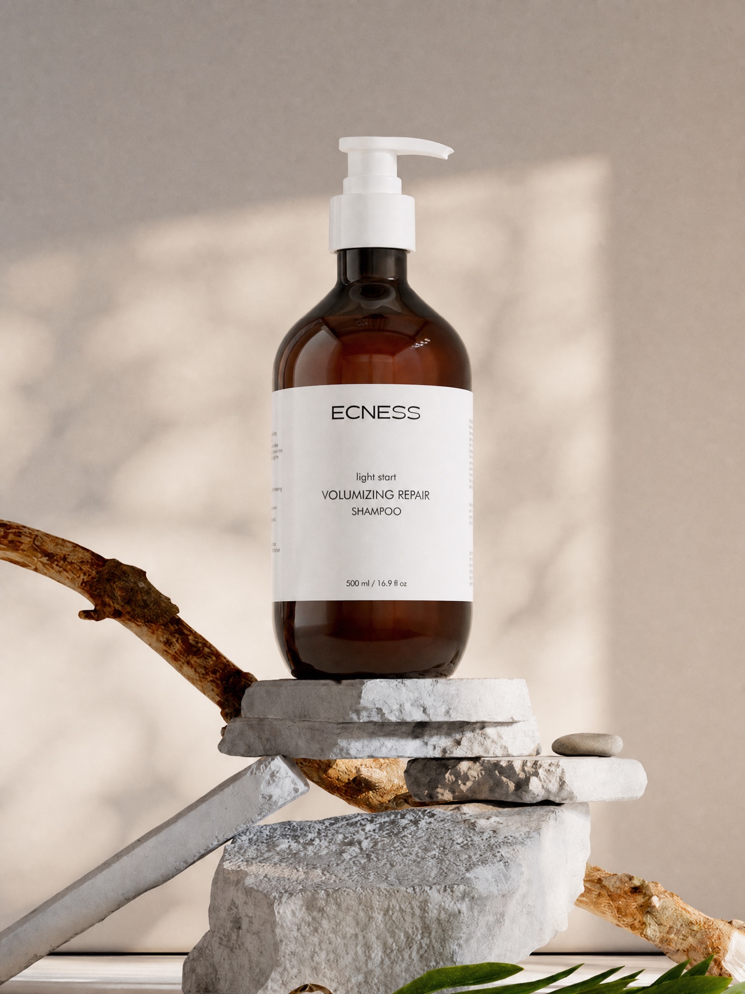 ECNESS Volumizing Repair Shampoo in a natural stone setting
